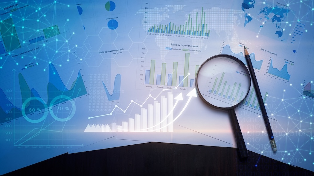 graphically designed photo with graphs, bars and statistics with a magnifying glass and pencil on top