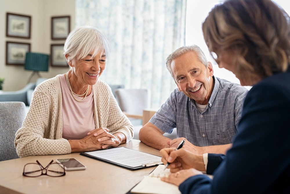 older couple talking to an advisor about tax-saving strategies for high earners