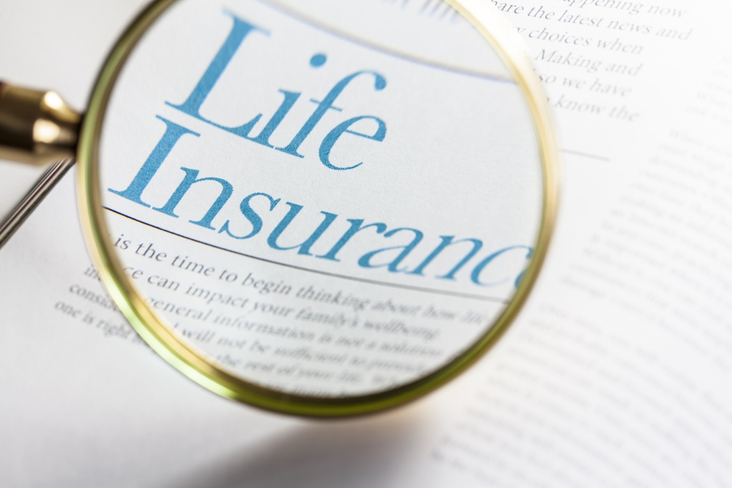 Life Insurance on magazine with magnifying glass.