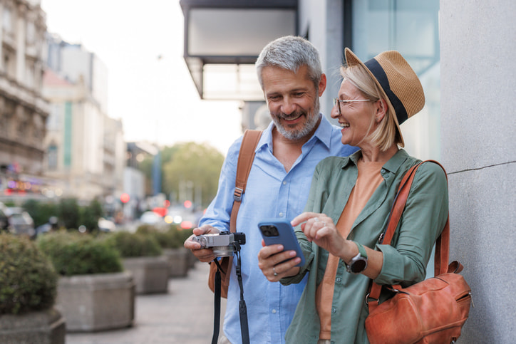 elderly couple looking at their credit card statements on their phone