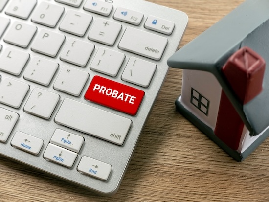 Keyboard next to a miniature of a home with probate as a big red key.